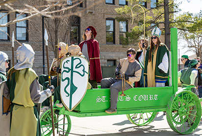 Students at a St. Pattys parade. Links to What to Give