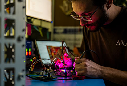 A student working on a project. Links to Gifts of Cash, Checks, and Credit Cards